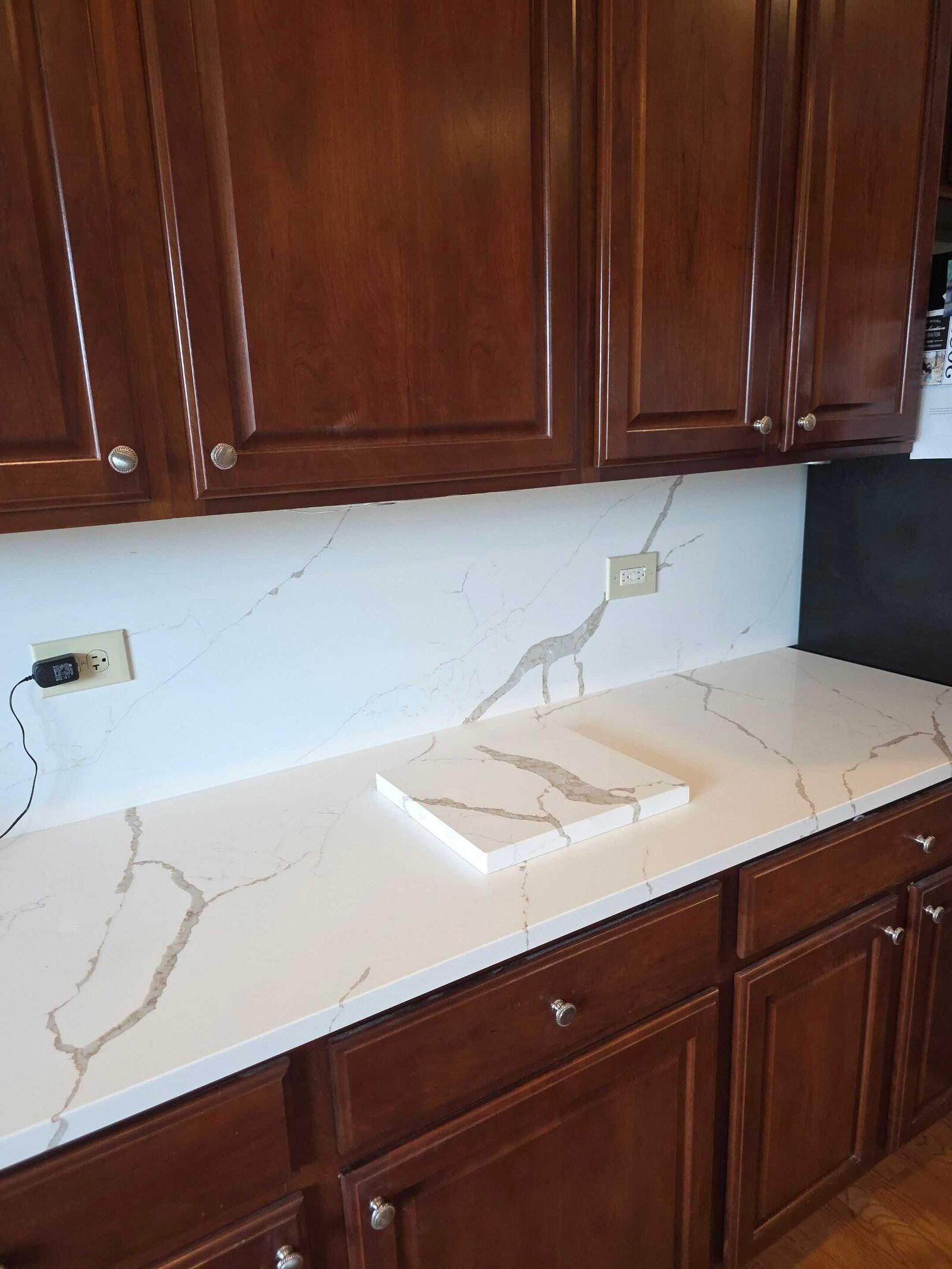 New quartz along the back run, the vein carrying the length of the counter under cherry uppers