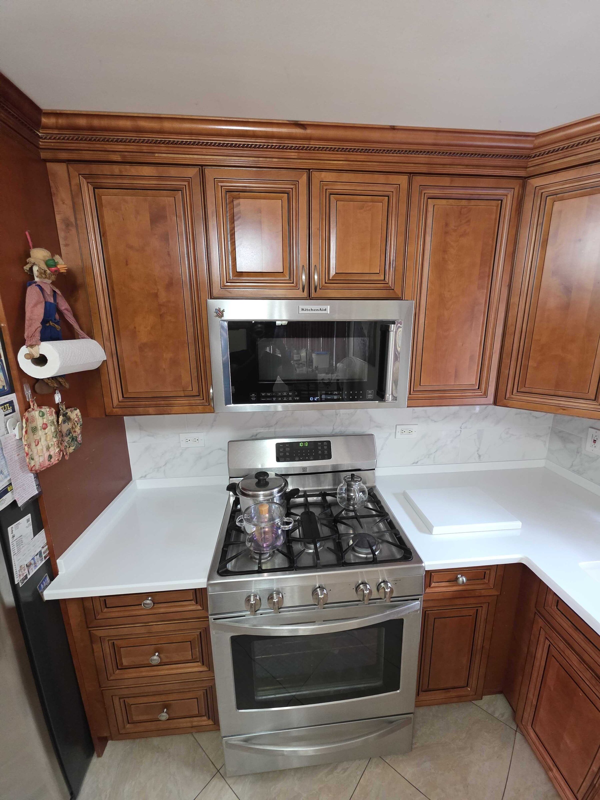 Quartz either side of the stainless range under cherry uppers
