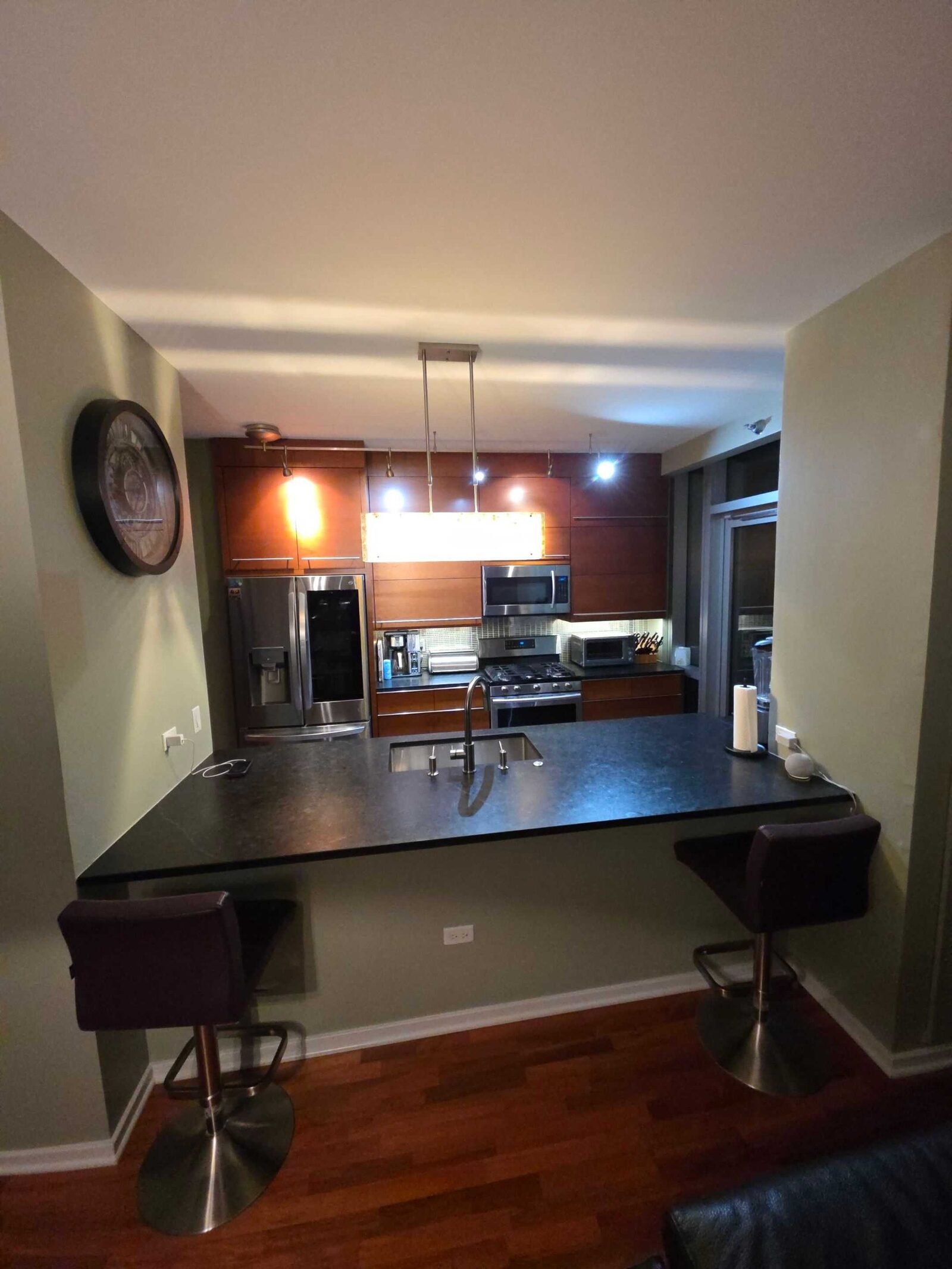 The same breakfast bar before, in a flat dark counter that swallowed the light
