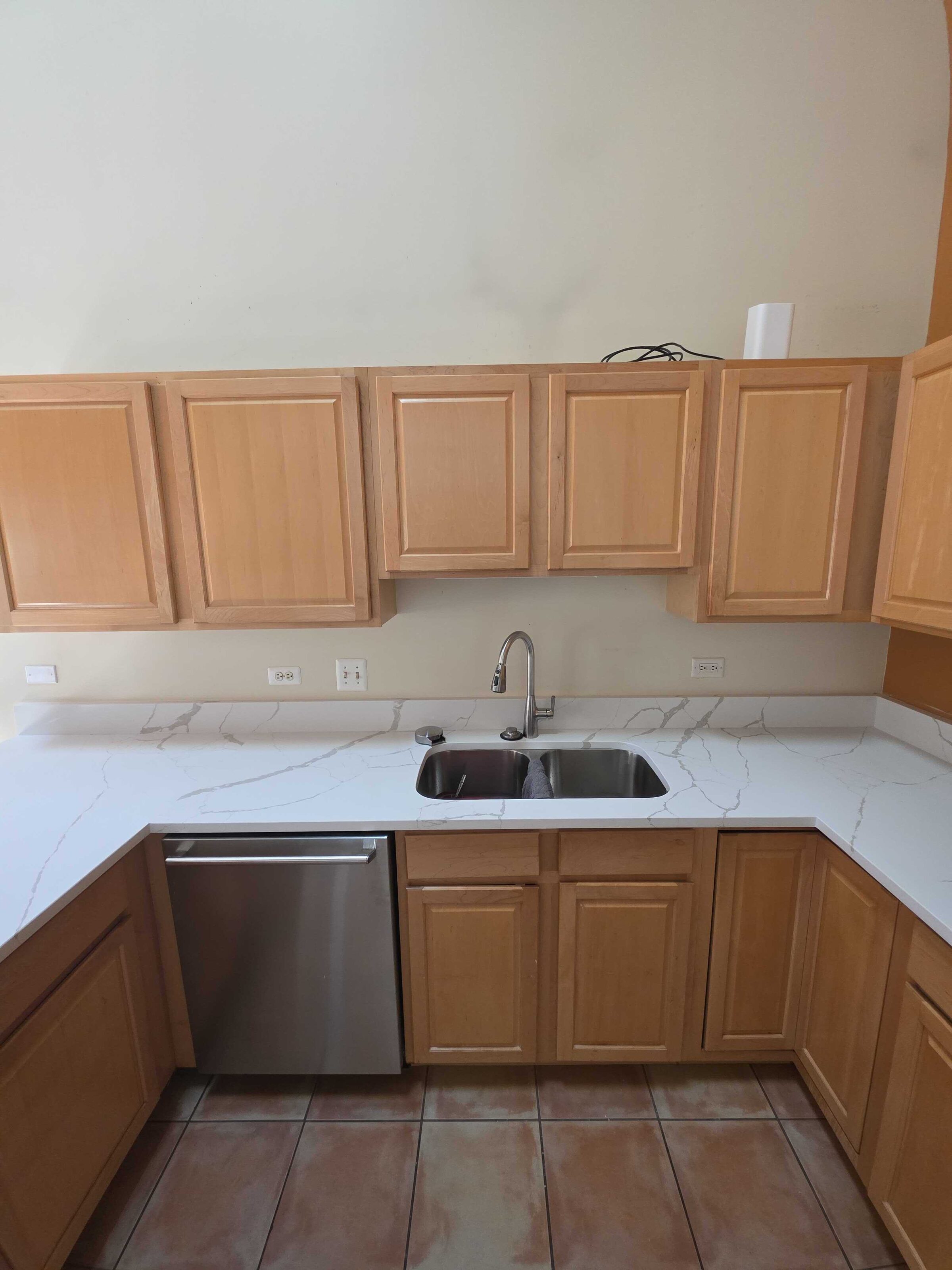 New quartz at the sink and dishwasher, oak uppers and terracotta floor