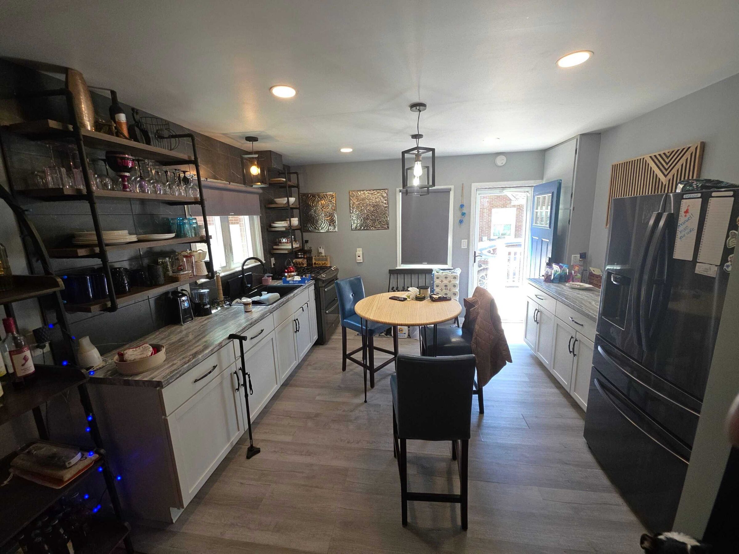 The kitchen before, looking down the length of the old gray laminate toward the back door